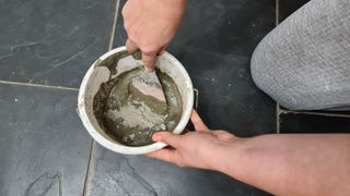 Mixing grout before applying on tiles