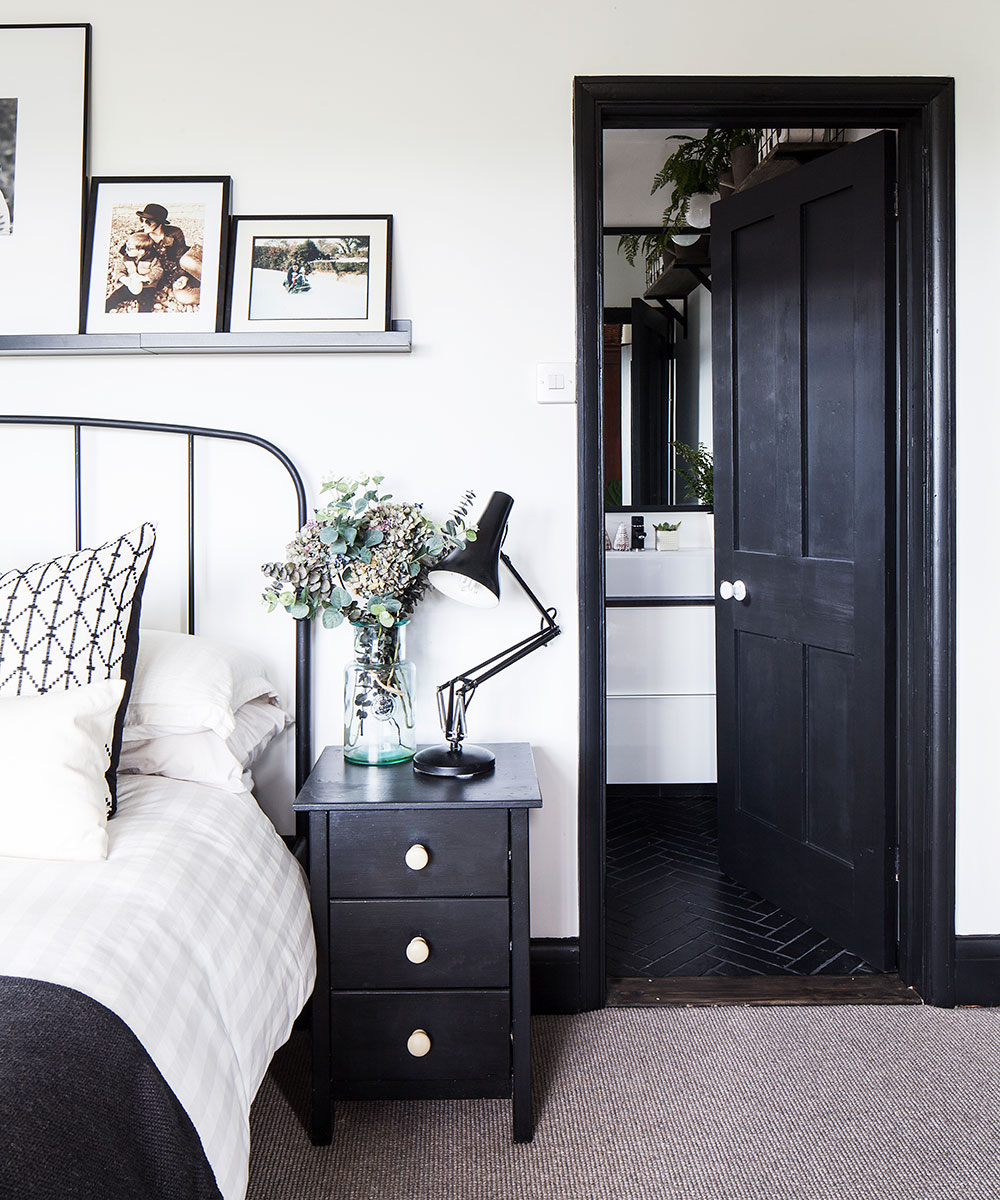 bedroom with bed chest of drawer and door