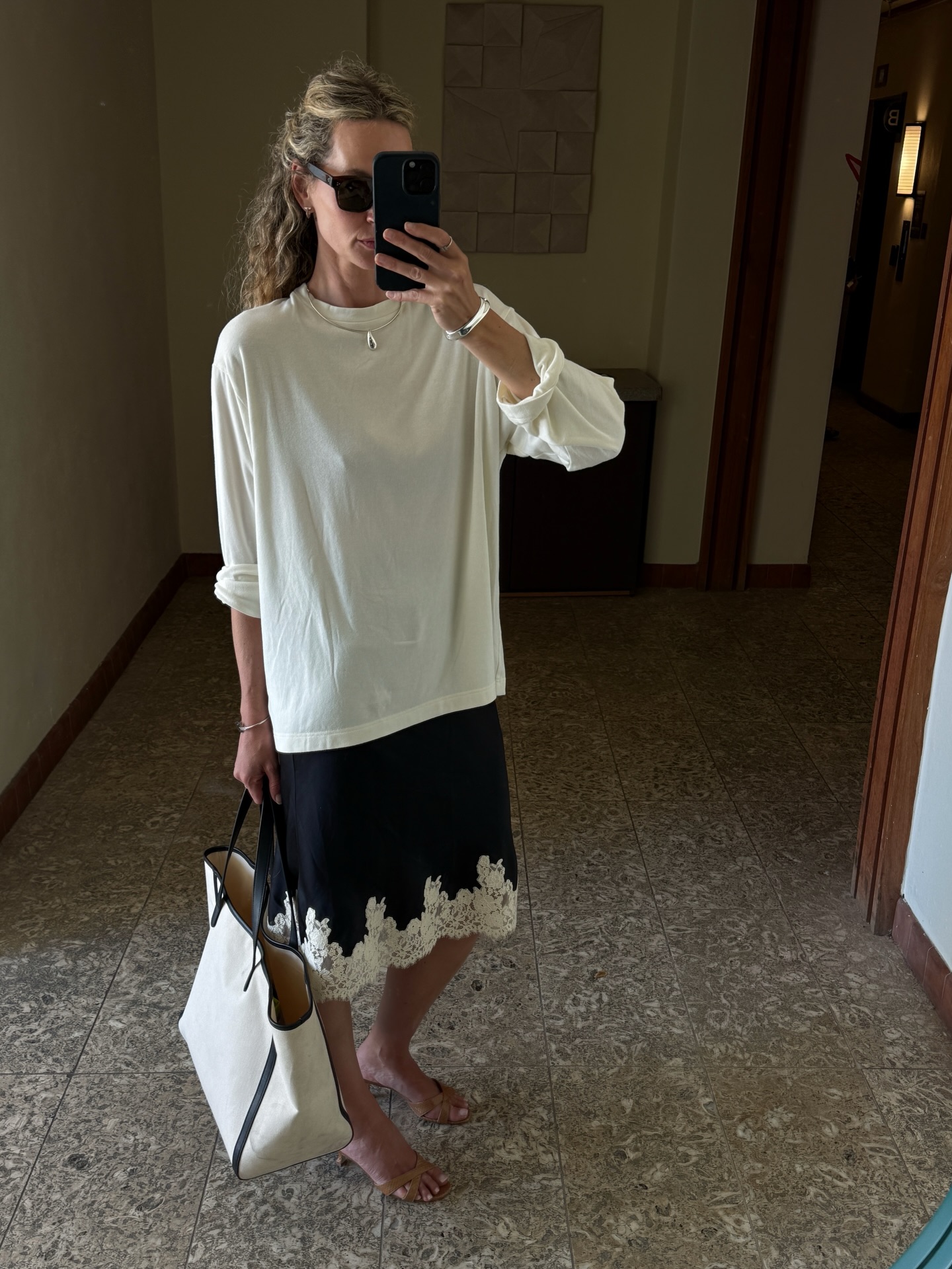An image of a woman wearing summer knee length skirt outfit 2026