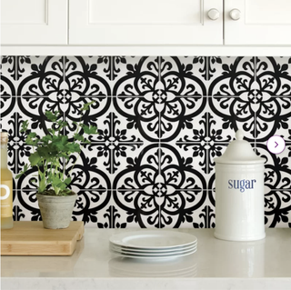 Black and white patterned peel-and-stick backsplash tile