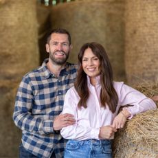 Kelvin and Liz Fletcher in front of hay 