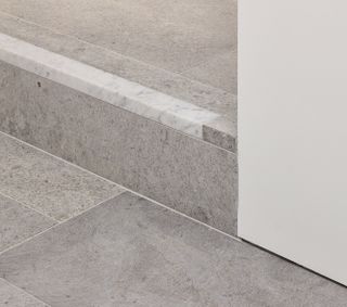 Limestone flooring covers both floors