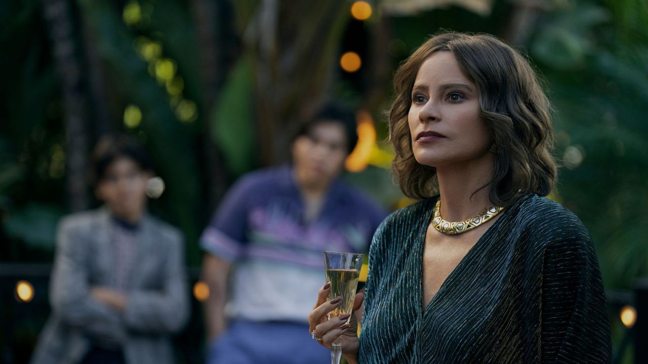 Sofia Vergara as Griselda holding champagne in episode 5