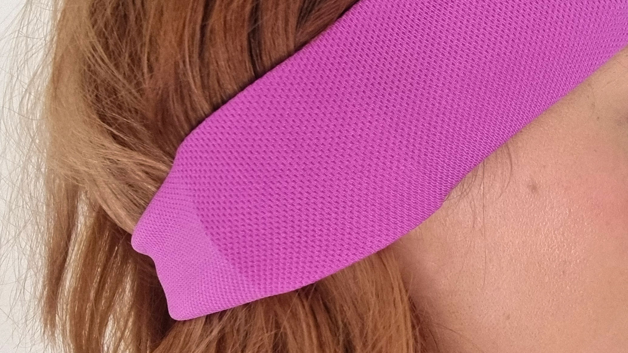 A close-up picture of our reviewer testing the AcousticSheep SleepPhones V8