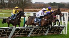 Three horses jump a hurdle during the Fighting Fifth Hurdle at Newcastle.