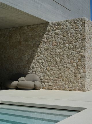 swimming pool and stone wall at Residence in Dionysos