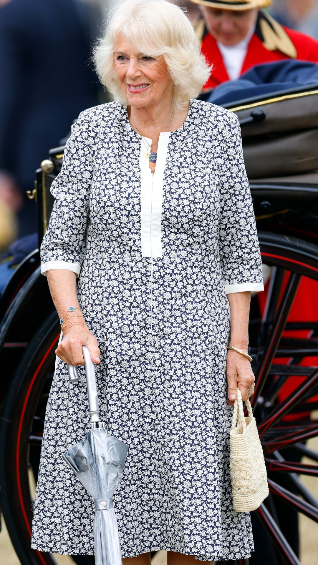 queen camilla holding a rixo woven bag