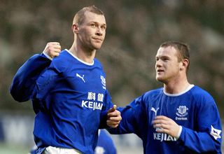 Duncan Ferguson celebrating a goal with a teammate while wearing an Everton jersey.