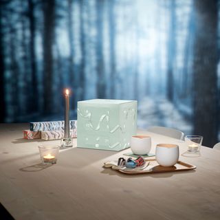 room with candle box on wooden table