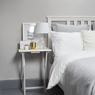 bedroom with grey coloured and white bed