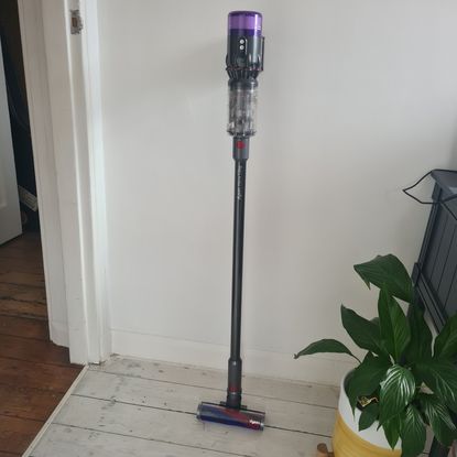 Dyson Micro 1.5kg standing against a wall