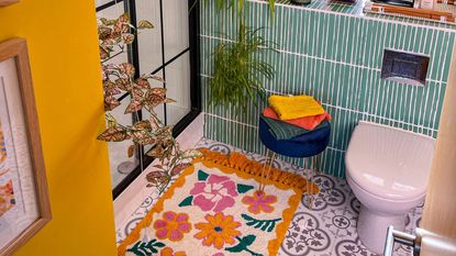 bathroom with yellow walls, patterned tile floor and walls - overatno18