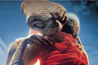 Still of ET hugging Henry Thomas in 'ET: The Extra-Terrestrial', the 1982 film.