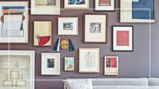 purple grey living room wall with a gallery wall of artwork