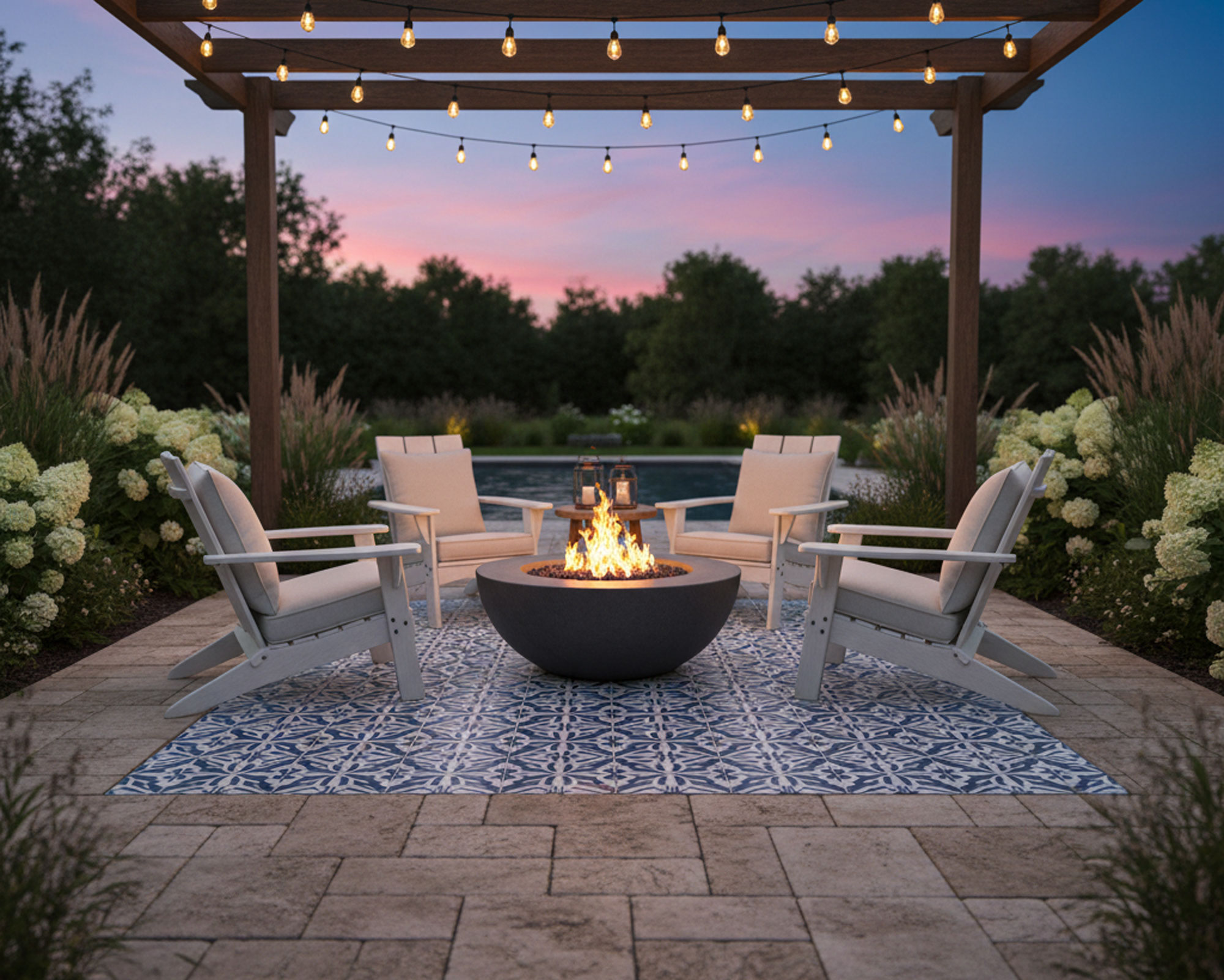 patio with mosaic tile 'rug' insert, pavers, pergola, garden chairs, fire pit, hydrangea and other shrubs