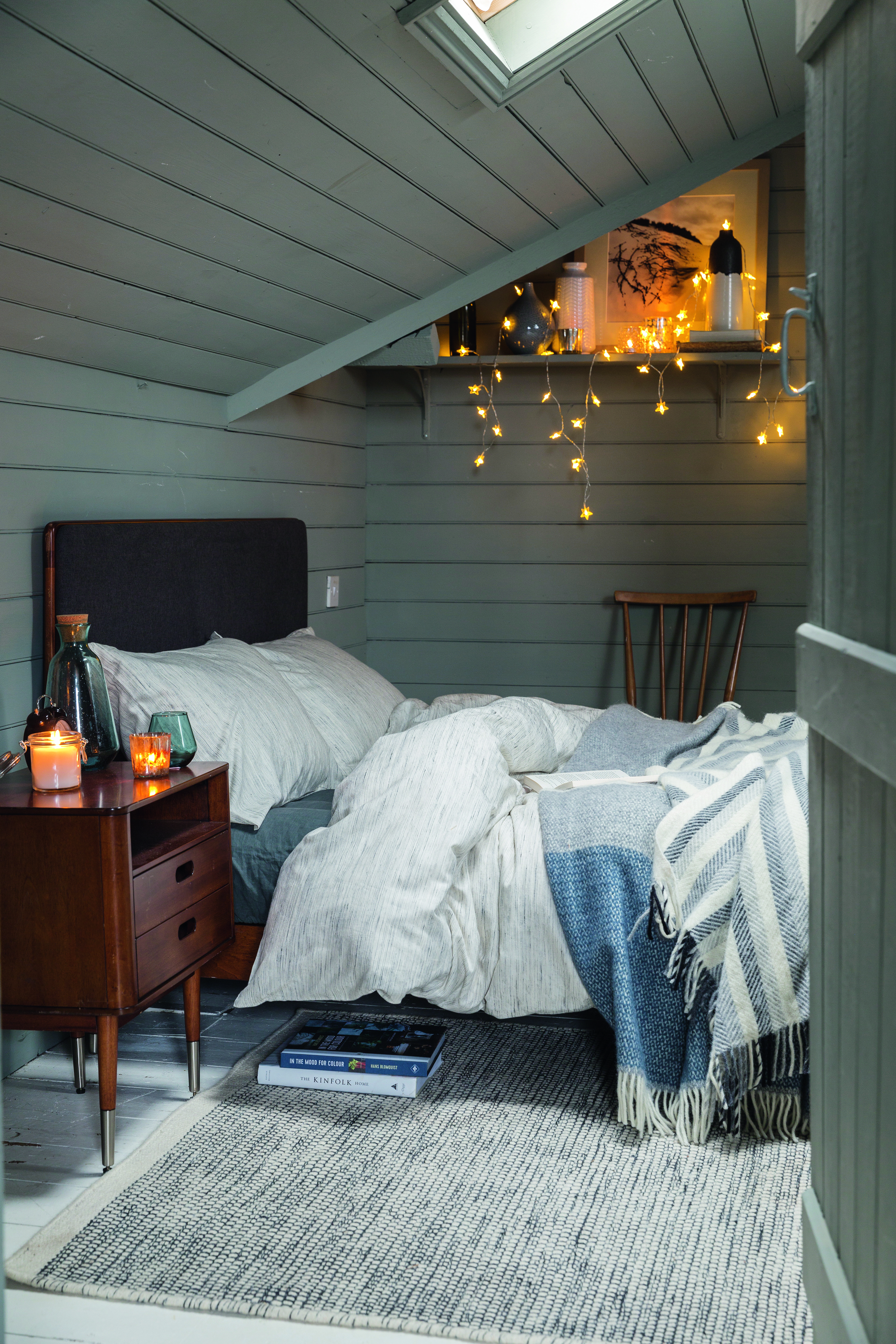 A Scandinavian style bedroom by Soak & Sleep with wall paneling and fairy lights