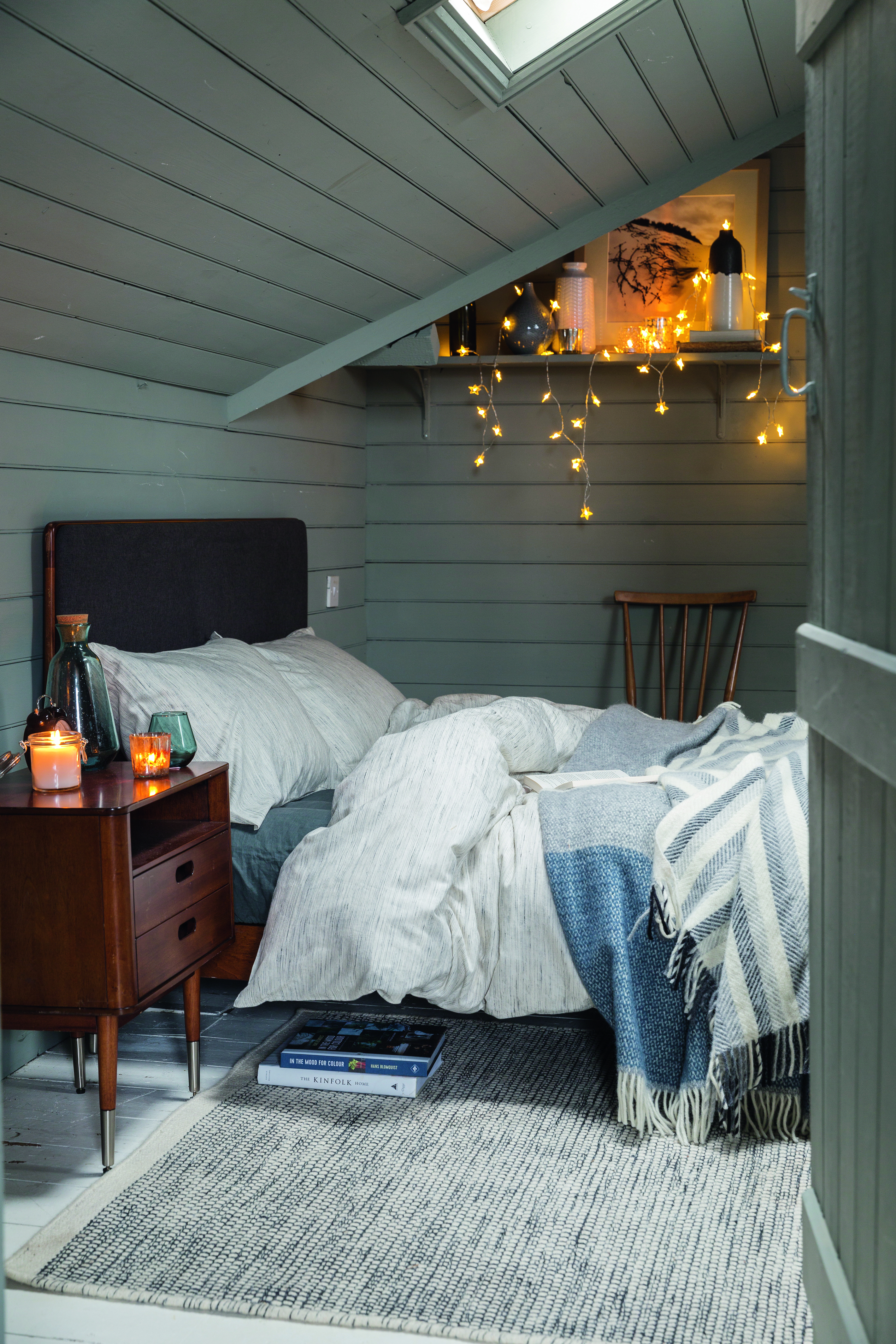 white and gray Scandinavian style bedroom by Soak & Sleep, with fairy lights on a shelf