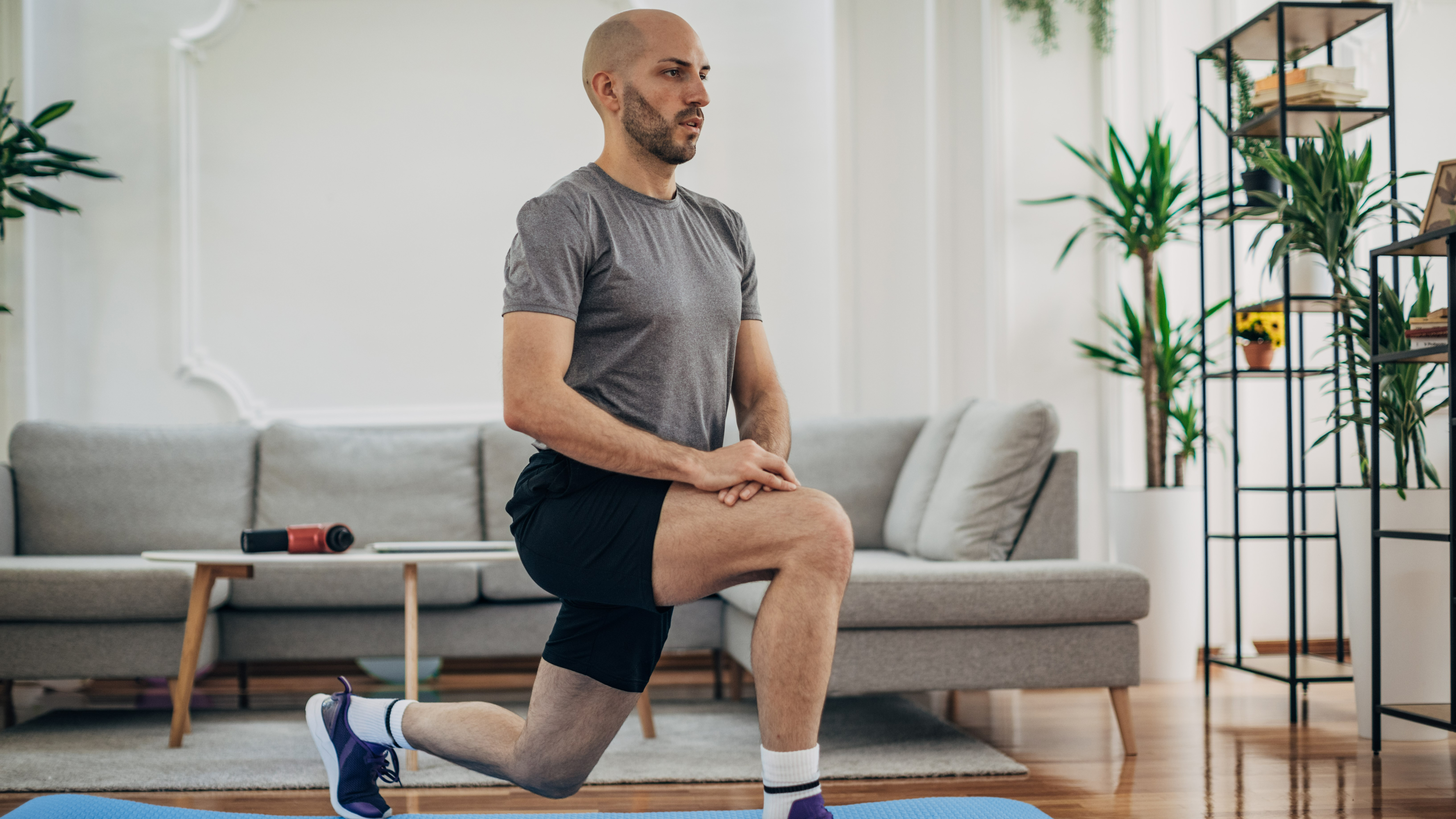 Man performing a lunge exercise at home
