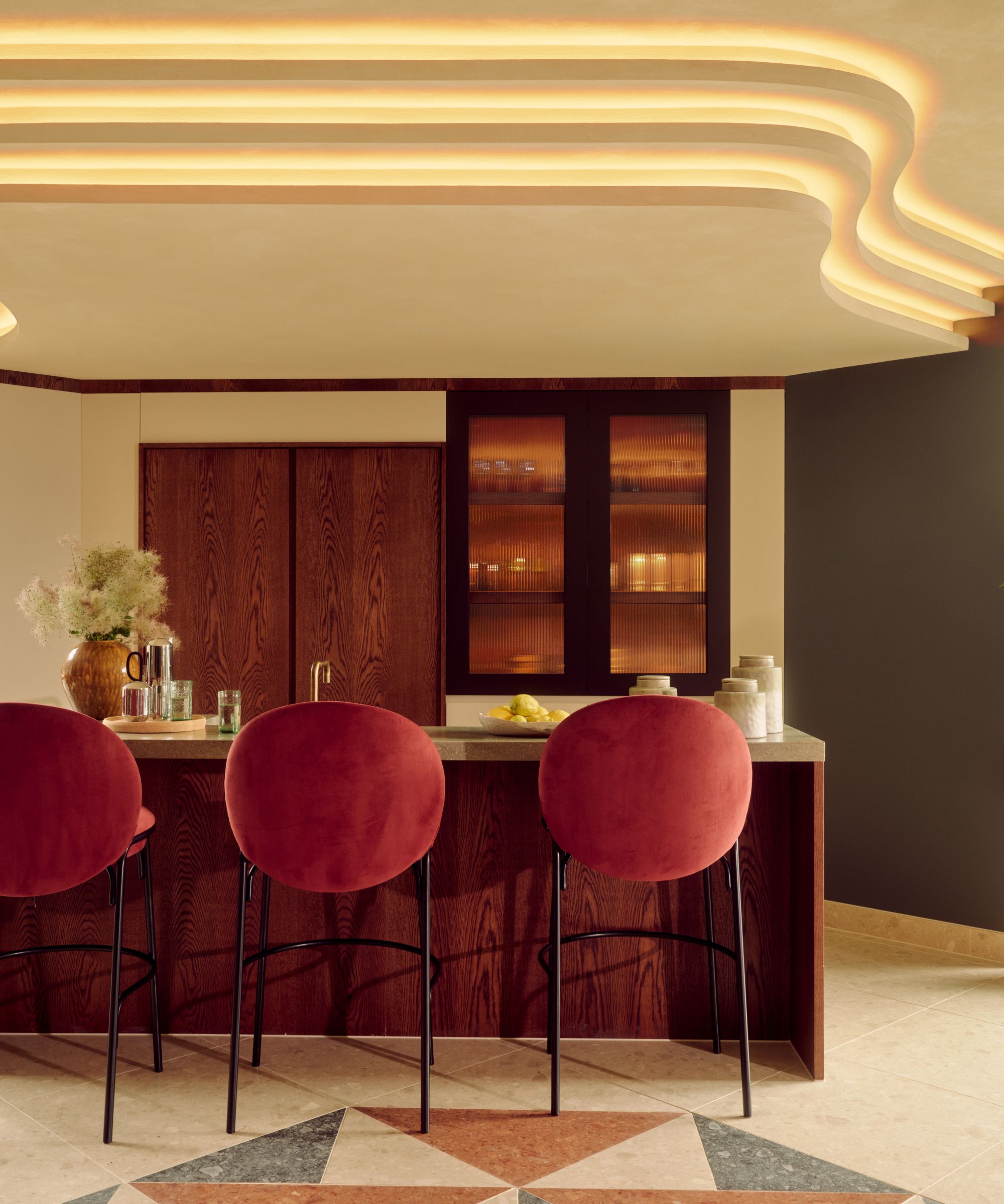 A retro kitchen with a wooden island and green countertops