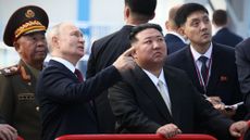 Russian President Vladimir Putin points out something to North Korean leader Kim Jong Un