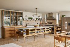 A large kitchen with wooden cabinets and herringbone floor tiles