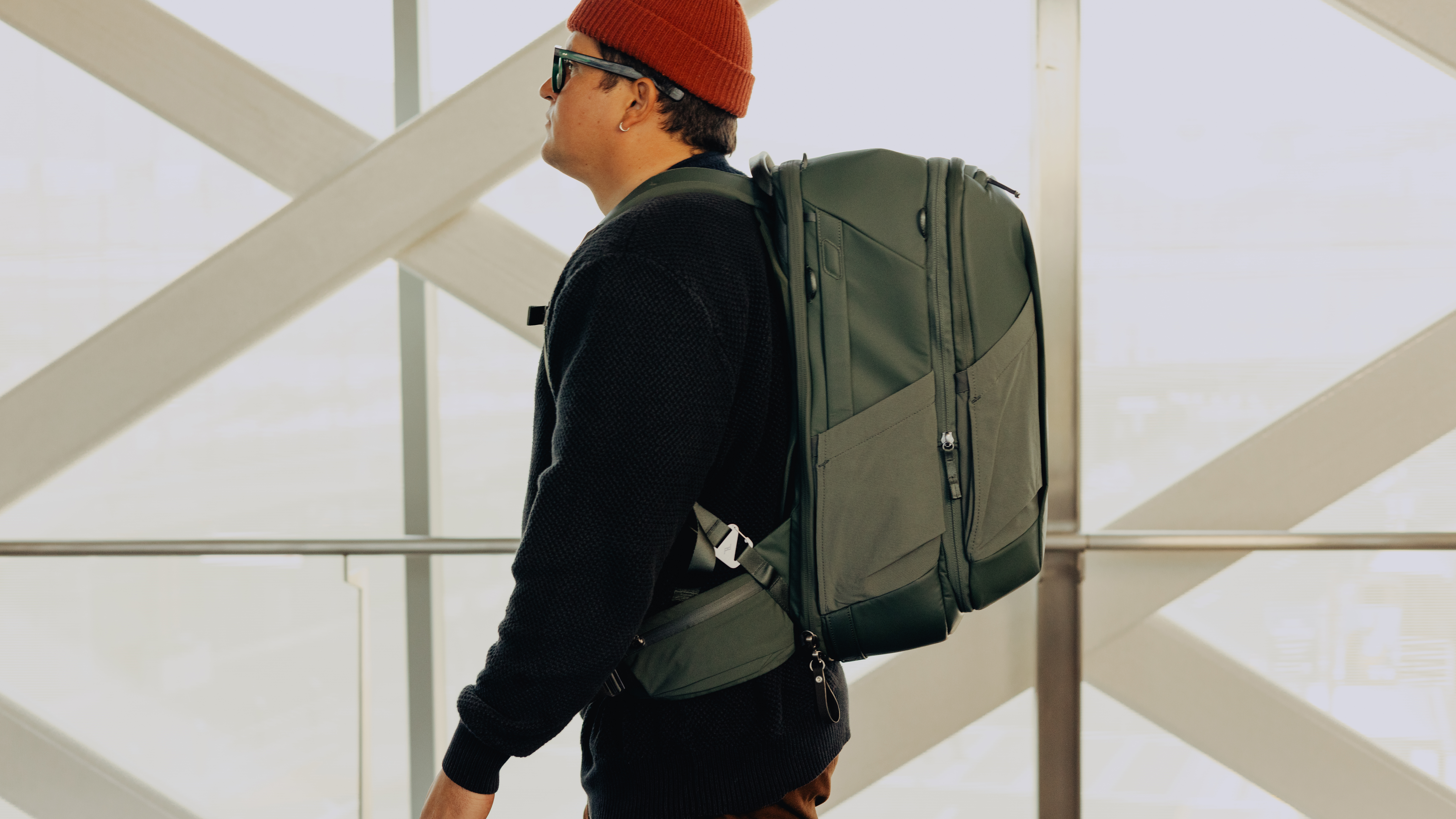 The Peak Design Travel 2-in-1 Backpack worn by a traveler