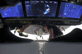 "GuinGuin," the flying penguin, floats below the touchscreen controls on board SpaceX's Crew Dragon "Endeavour." The Crew-2 astronauts, including NASA astronaut Megan McArthur (at right) flew the doll as their traditional zero-g indicator, as selected by their children.