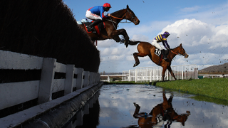 Derek Fox (r) riding Corach Rambler takes the water jump on his way to winning the Ultima Handicap Chase during day one of the Cheltenham Festival 2023 at Cheltenham Racecourse on March 14, 2023 in Cheltenham, England. 