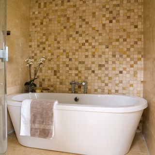 bathroom with tiles on wall and bathtub