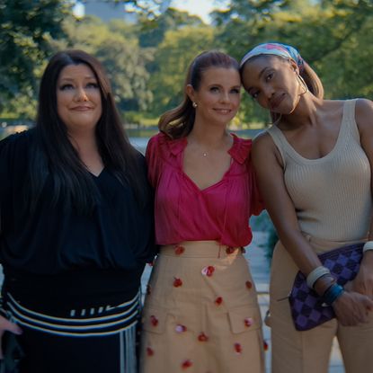 Brooke Elliott as Dana Sue Sullivan, JoAnna Garcia Swisher as Maddie Townsend, Heather Headley as Helen Decatur with their arms around each other in summer clothes smiling standing in a sunny central park in new york city