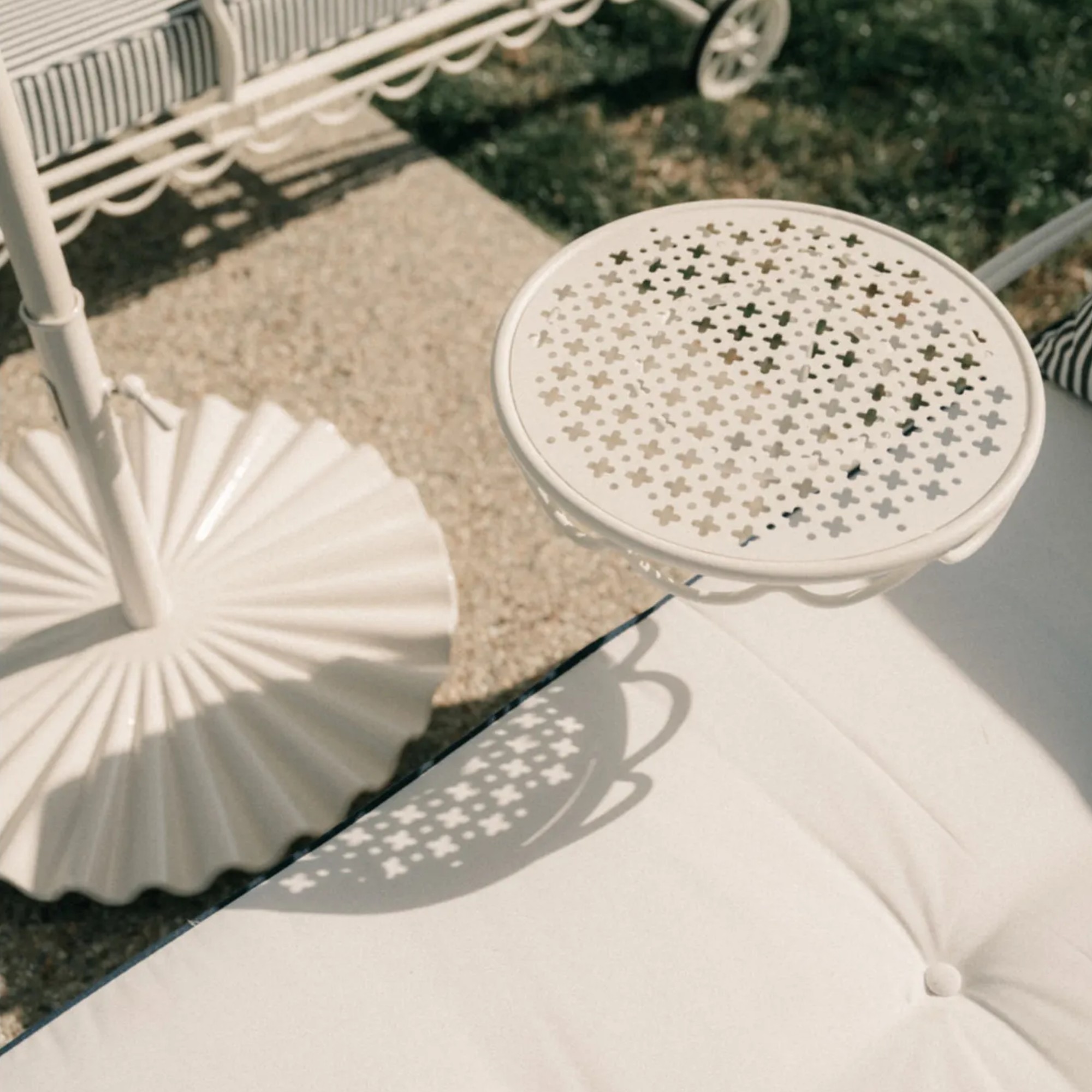 Business &amp;amp; Pleasure Co. Molded Parasol Stand in white next to a sun lounger
