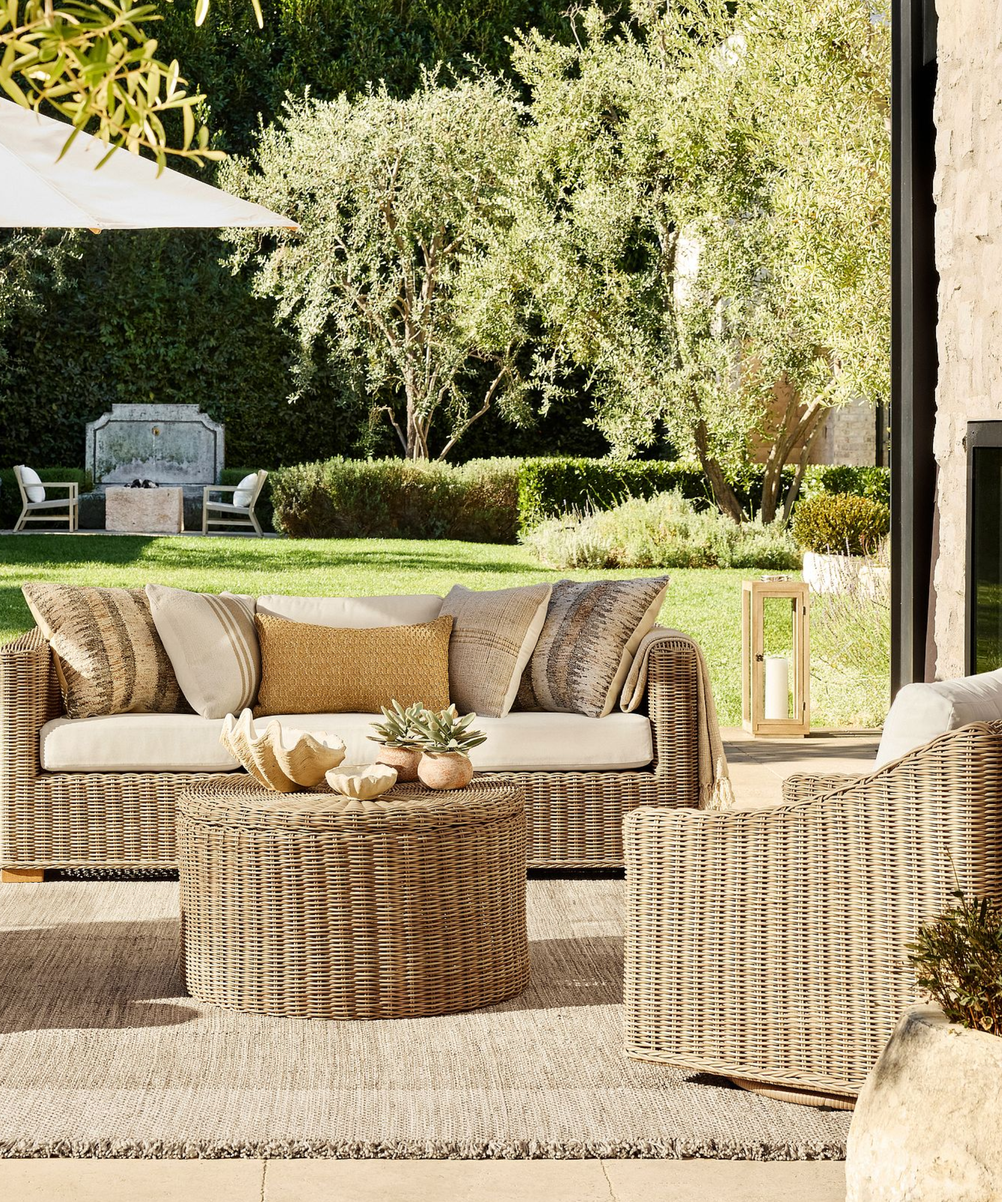 a backyard with outdoor seating and a storage coffee table