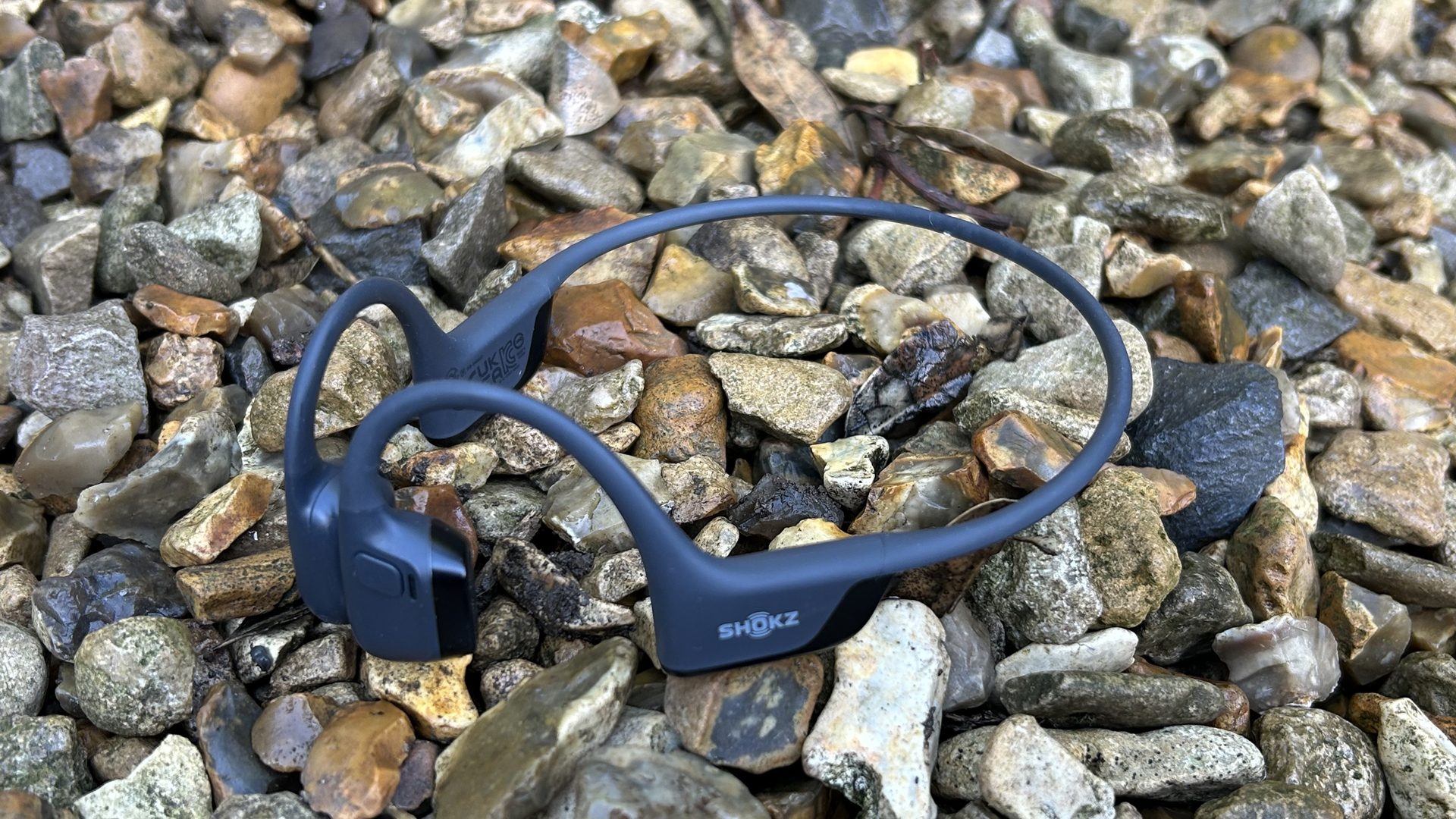 Shokz OpenRun Pro 2 headphones on some gravel
