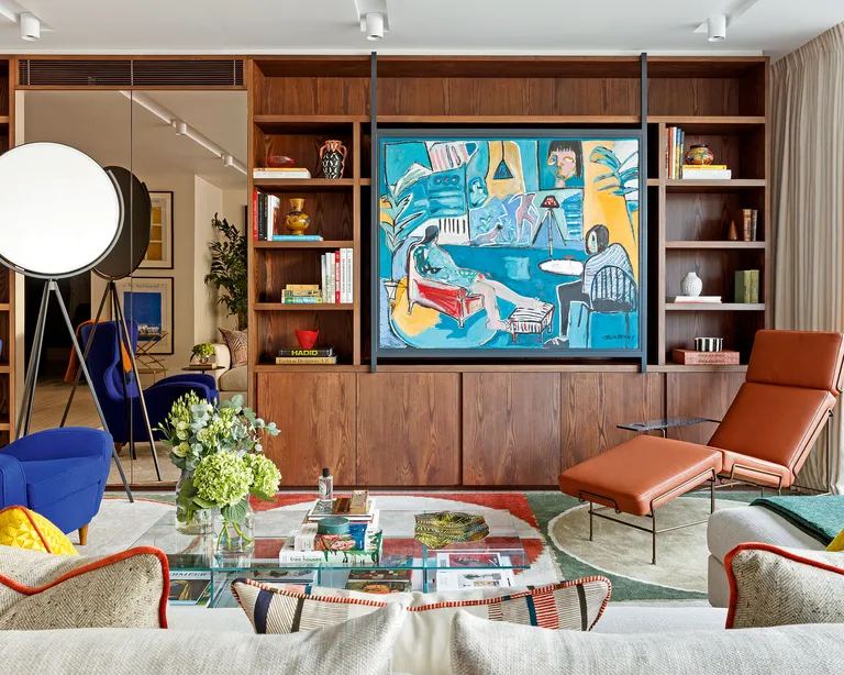 Living room with wood shelving and bold art