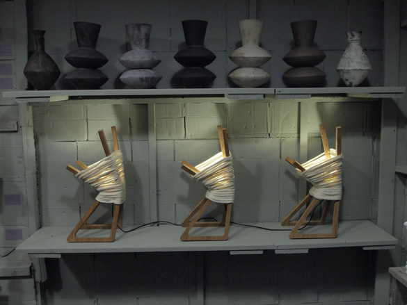 Three lamps on a table made out of chopsticks