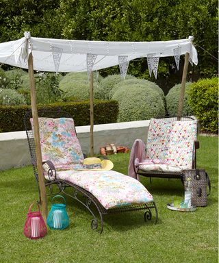 Garden party ideas with sun loungers under canopy