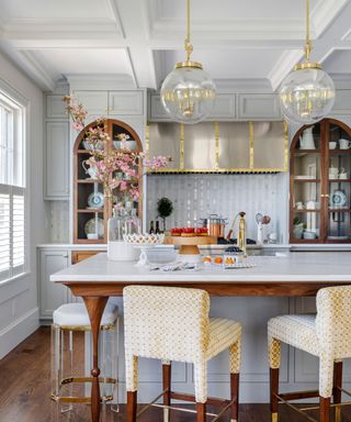 A blue and white kitchen with large, arched cabinets