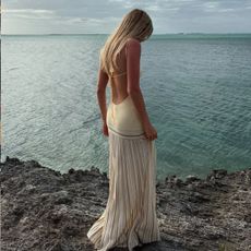 An image of @caitlinburnhamm wearing a striped dress while in Greece, one of the biggest dress trends of 2025.