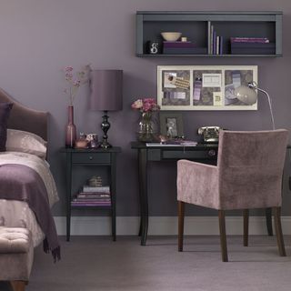 bedroom with purple home office with matching floating shelves