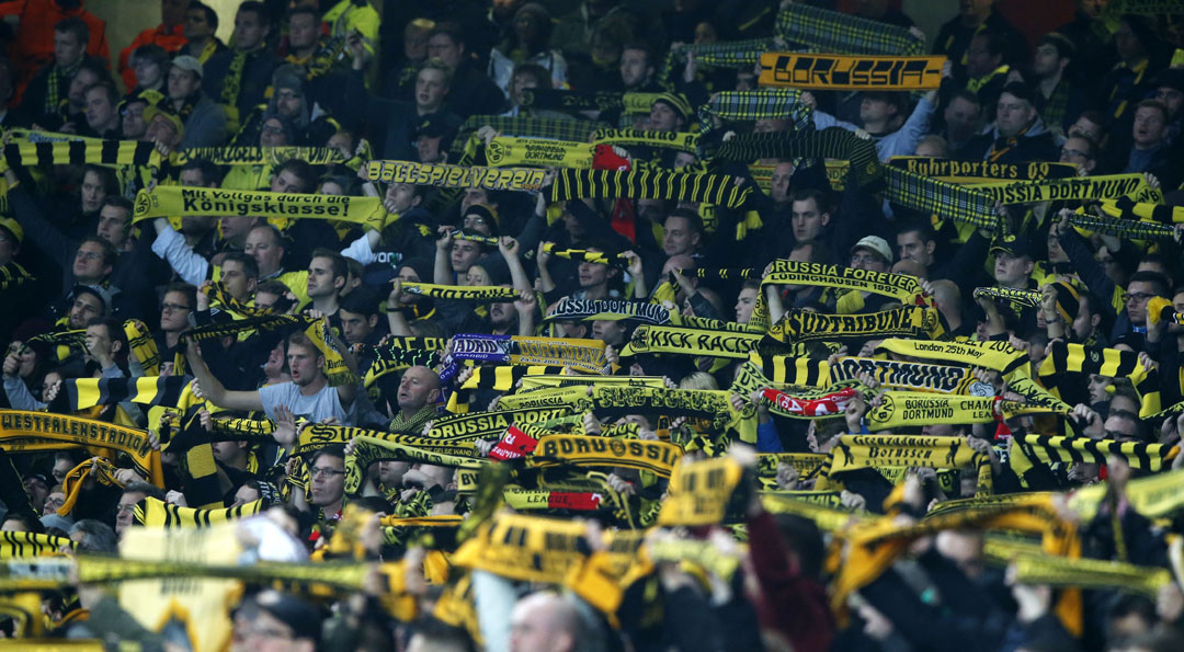 Dortmund fans hold aloft their scarves