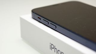 Corner of a blue iPhone 12 on its box