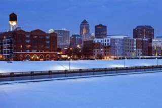 Des Moines skyline across frozen river.