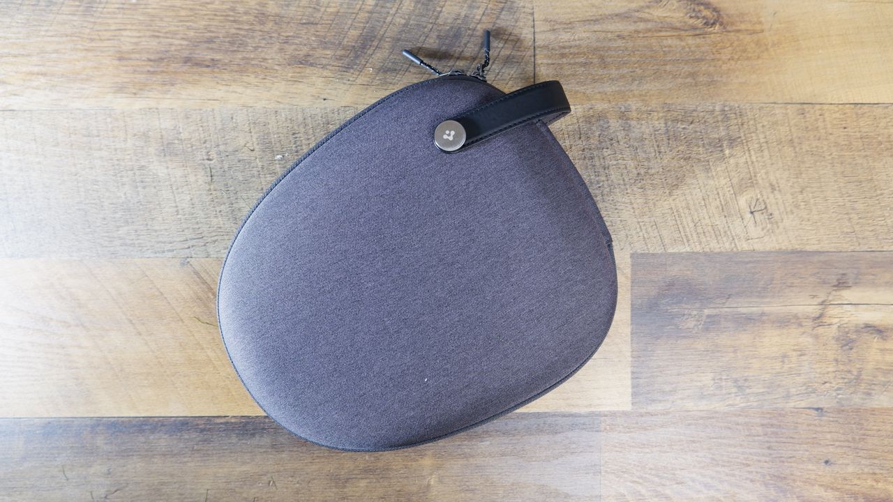 Spigen Klasden AirPods Max Case in gray on a wooden floor