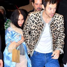 Zo&euml; Kravitz wearing a light-blue silk coat with fur trim from Conner Ives while attending the SNL after party with Harry Styles.