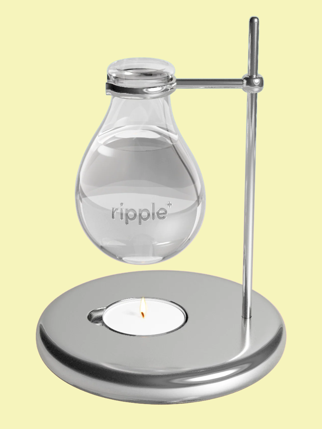 A chrome oil burner with a glass holder