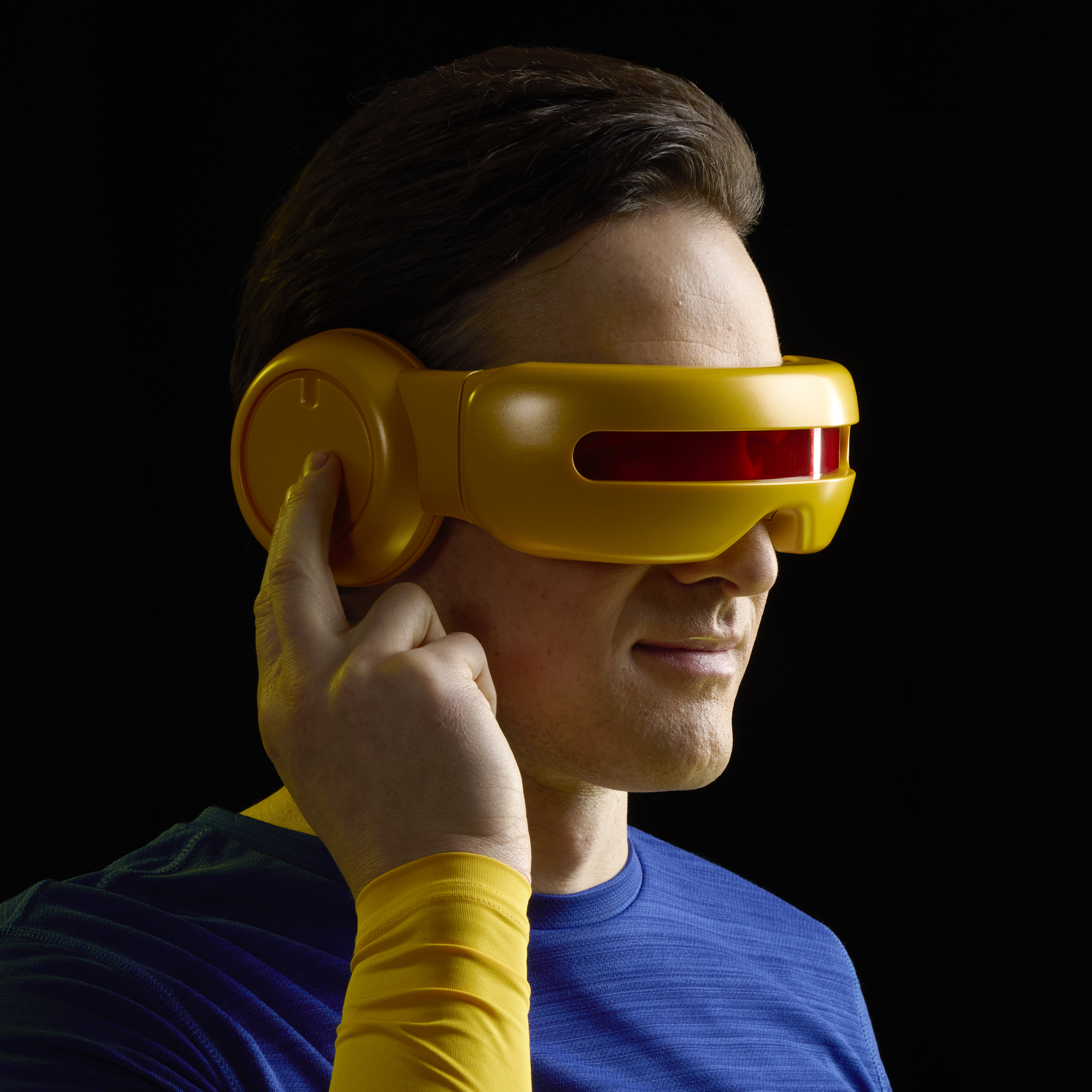 A man holds the Cyclops Premium Roleplay Visor up in a dark room
