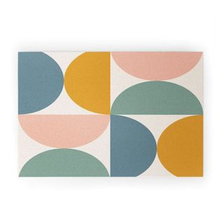 A welcome mat with multi-colored half oval shapes