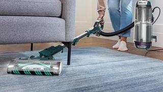 Shark PowerDetect Self-Empty Robot Vacuum vacuuming under a sofa