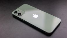 The iPhone 12 mini face-down on a desk