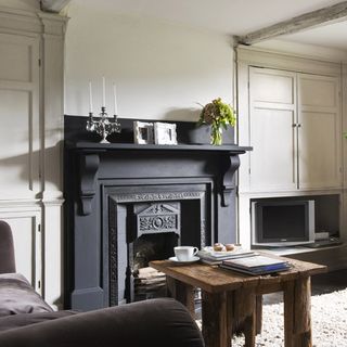room with white walls and grey fireplace